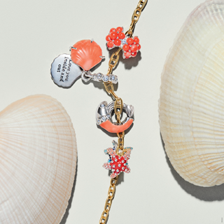 Add a splash of summer to your story with radiant new charms in coral and sparkle.